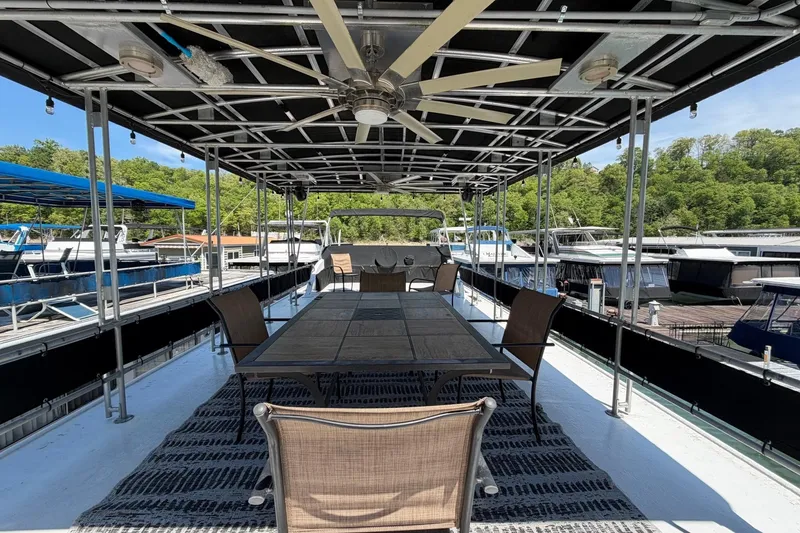 Slide: The Image of Rooftop deck of 1989 Sumerset 14x62 houseboat with dining area and ceiling fan. - 32