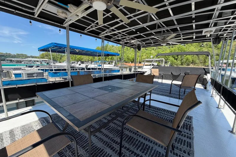 Slide: The Image of Outdoor seating area on 1989 Sumerset 14x62 houseboat with table and chairs. - 35
