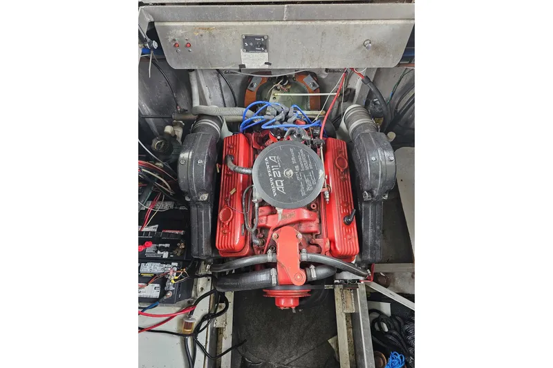 Slide: The Image of Engine compartment of a 1989 Sumerset 14x62 houseboat with visible wiring and components. - 40