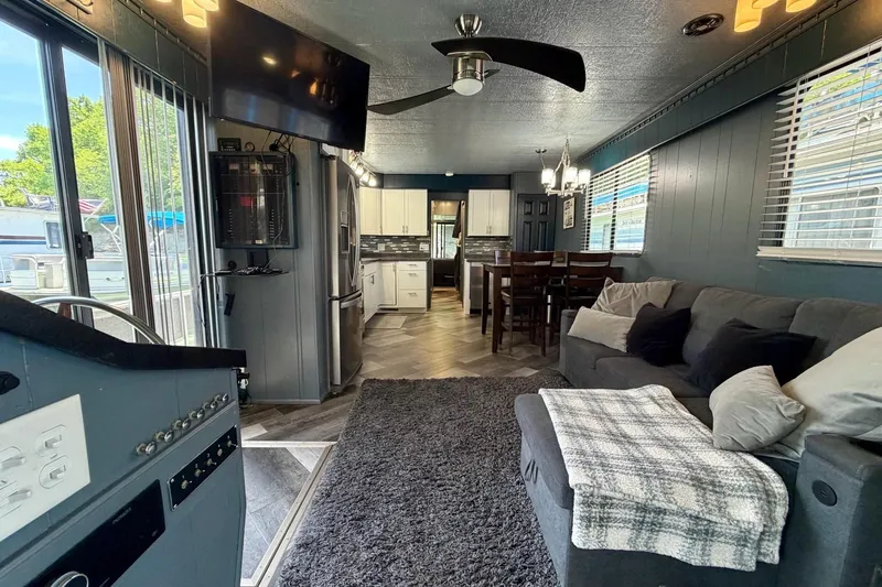 Slide: The Image of Interior of a 1989 Sumerset 14x62 houseboat with modern decor and cozy furnishings. - 5
