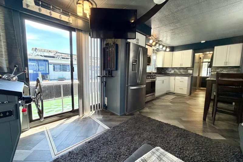 Slide: The Image of Interior of a 1989 Sumerset 14x62 houseboat with modern kitchen and living area. - 6