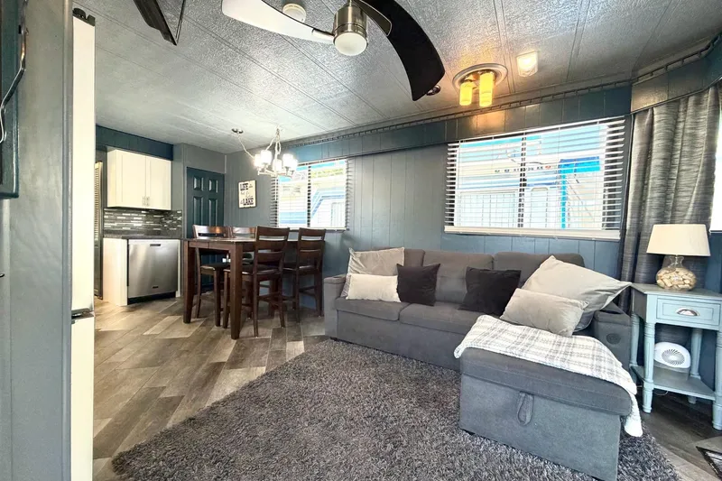 Slide: The Image of Interior of 1989 Sumerset 14x62 houseboat with modern decor and cozy living area. - 7