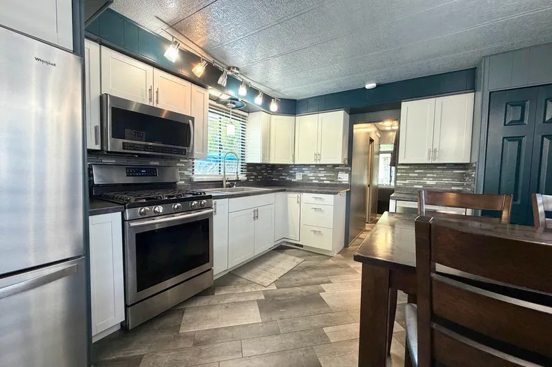 Slide: The Image of Modern kitchen in a 1989 Sumerset 14x62 houseboat with stainless steel appliances. - 9