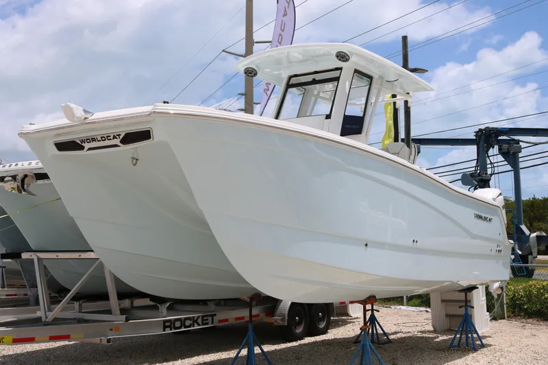 The Image of 2026 World Cat 265 CC-X boat on display, elevated on stands outdoors. - 0