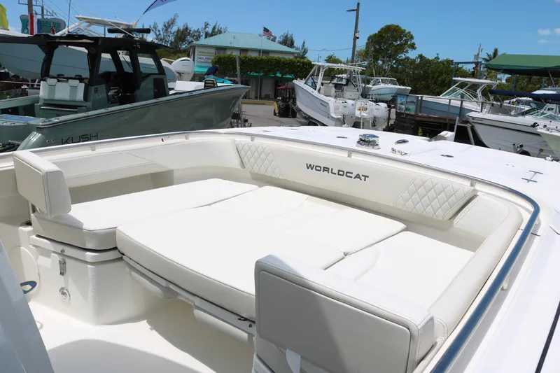 Slide: The Image of 2026 World Cat 265 CC-X boat with spacious white seating at a marina. - 12