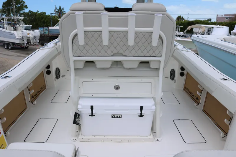 Slide: The Image of 2026 World Cat 265 CC-X boat interior with seating, storage, and Yeti cooler. - 16