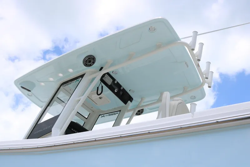 Slide: The Image of 2026 World Cat 265 CC-X boat, featuring sleek design and modern amenities against a blue sky. - 5