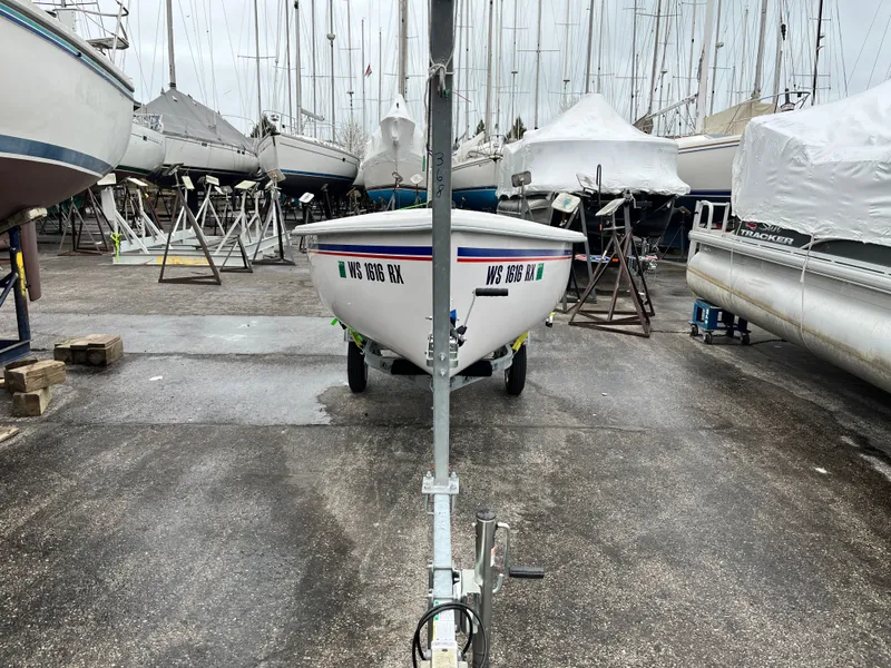 Slide: The Image of 2024 Catalina Expo 14.2 sailboat on a trailer in a marina. - 6