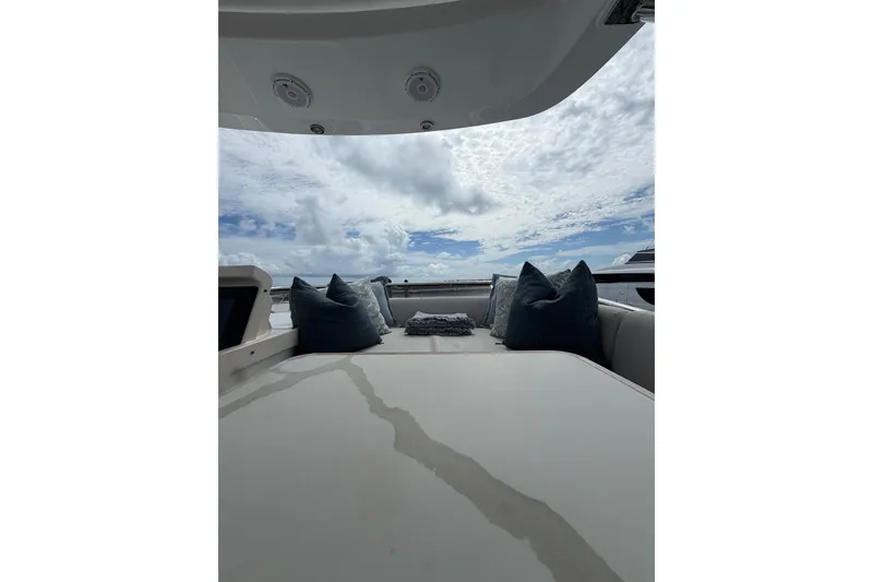 Slide: The Image of Luxurious seating area on 2024 Azimut Fly 50 yacht under a cloudy sky. - 13