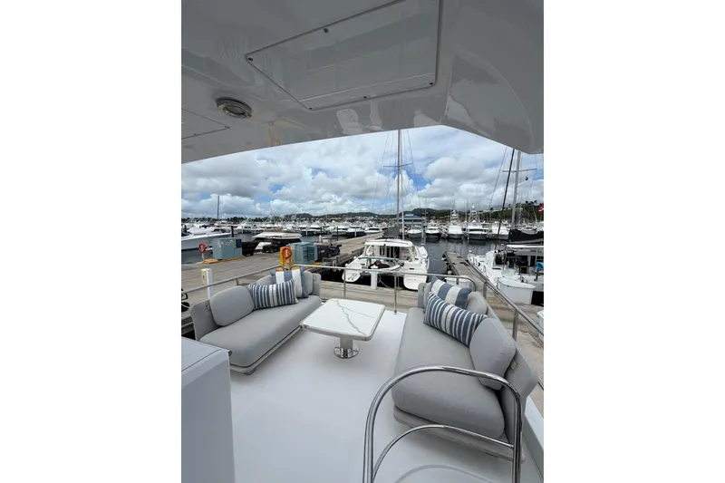 Slide: The Image of Luxurious 2024 Azimut Fly 50 yacht with elegant seating, docked at a marina under cloudy skies. - 20