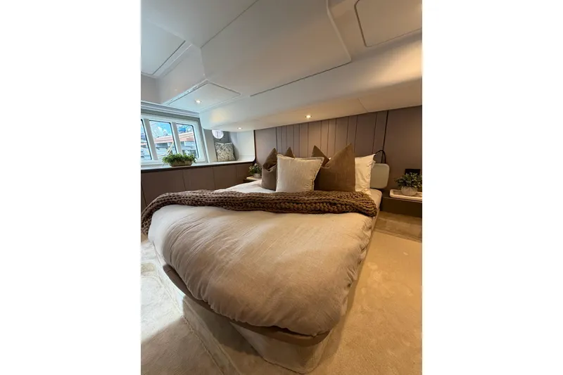 Slide: The Image of Luxurious bedroom interior of 2024 Azimut Fly 50 yacht with plush bedding and elegant decor. - 24