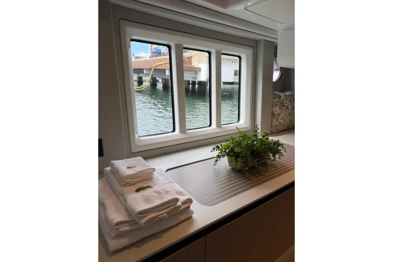 Slide: The Image of Interior view of 2024 Azimut Fly 50 yacht with window, towels, and plant. - 26