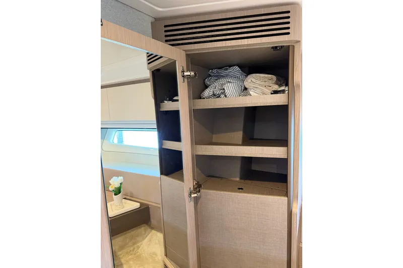 Slide: The Image of Open wardrobe with shelves inside Azimut Fly 50 yacht, 2024 model. - 30