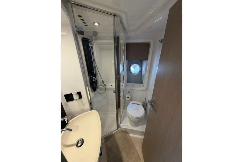 Slide: The Image of Luxurious bathroom in 2024 Azimut Fly 50 yacht with modern fixtures and porthole window. - 32