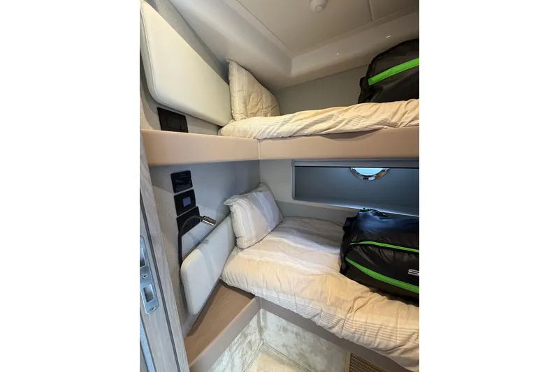 Slide: The Image of 2024 Azimut Fly 50 yacht cabin with bunk beds and luggage. - 34