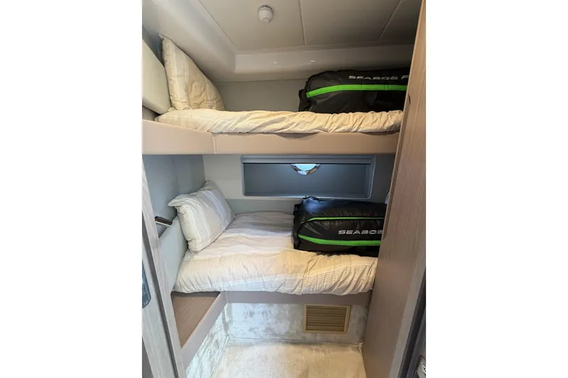 Slide: The Image of 2024 Azimut Fly 50 yacht cabin with bunk beds and Seabob bags. - 35