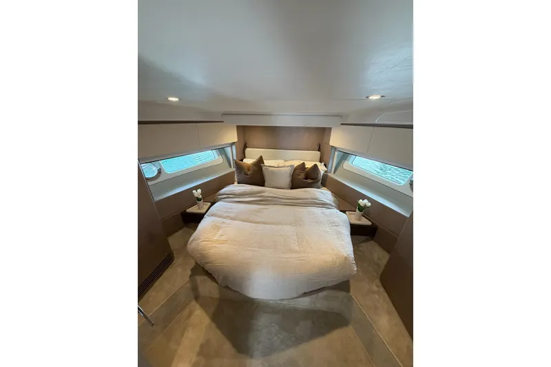 Slide: The Image of Luxurious bedroom interior of 2024 Azimut Fly 50 yacht with elegant bedding and side windows. - 36
