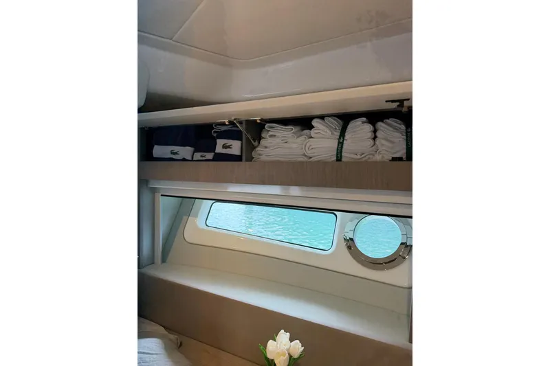 Slide: The Image of Luxurious interior of 2024 Azimut Fly 50 yacht with neatly stored towels and scenic window view. - 37