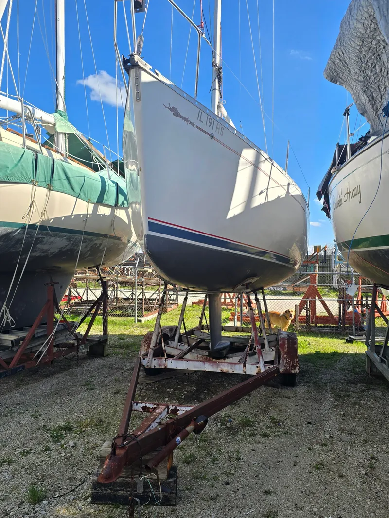 The Image of 1994 Beneteau First 265 sailboat on a trailer outdoors. - 0