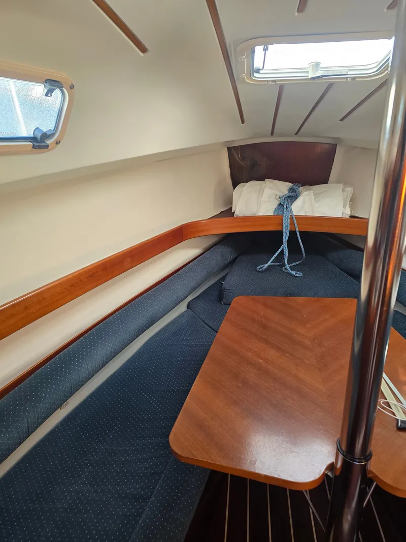 Slide: The Image of Interior of a 1994 Beneteau First 265 yacht with wooden table. - 11