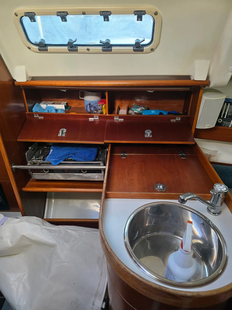 Slide: The Image of Galley area of a 1994 Beneteau First 265 yacht with sink and storage. - 12
