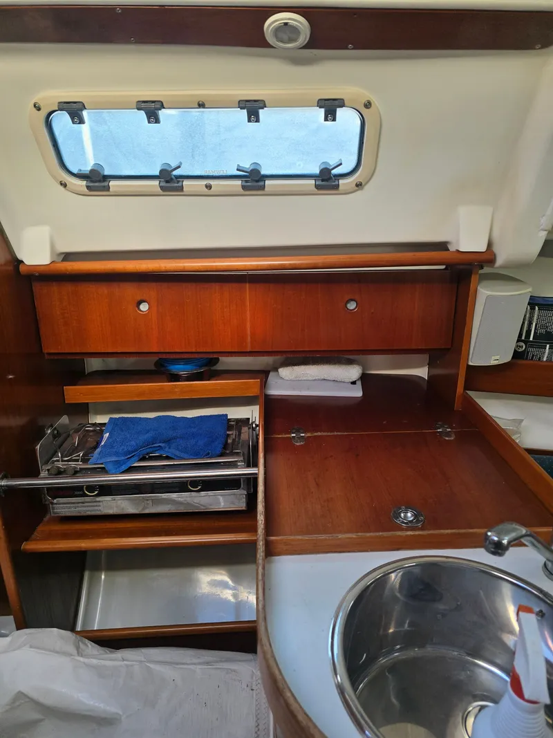 Slide: The Image of Interior of 1994 Beneteau First 265 yacht with wooden cabinetry and sink. - 13