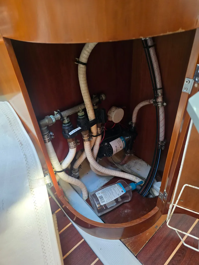Slide: The Image of Interior of a 1994 Beneteau First 265 showing plumbing. - 15