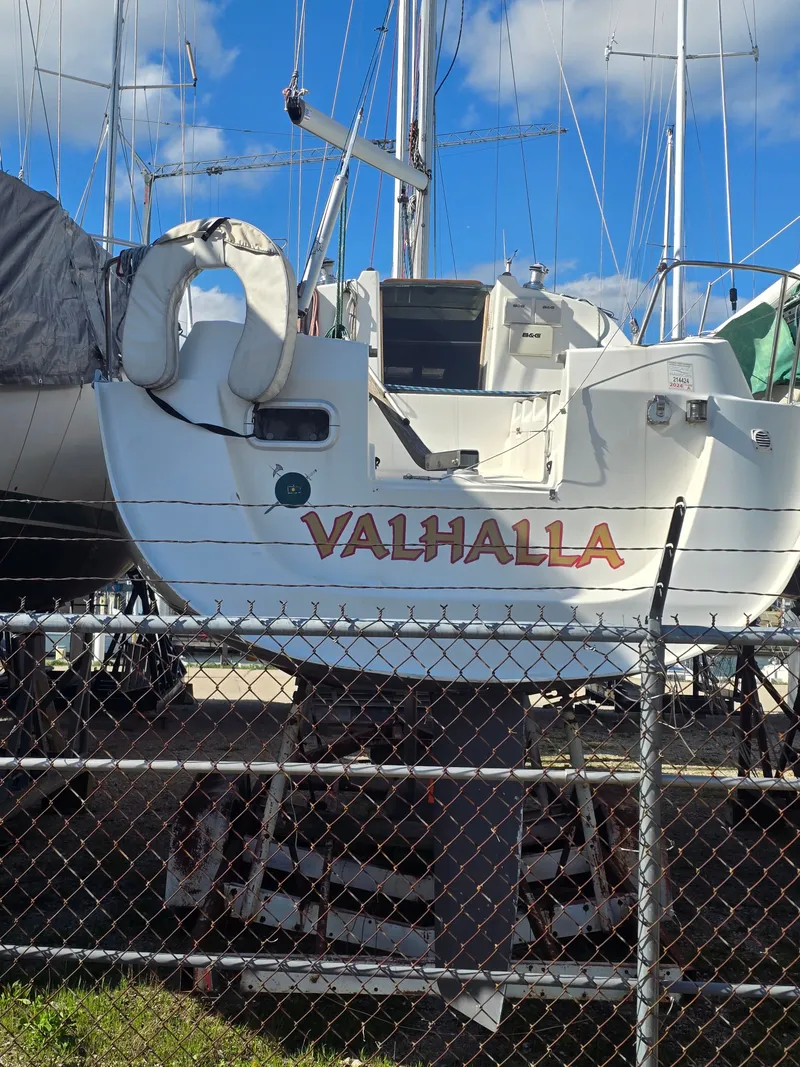 Slide: The Image of 1994 Beneteau First 265 sailboat named Valhalla on dry dock. - 2