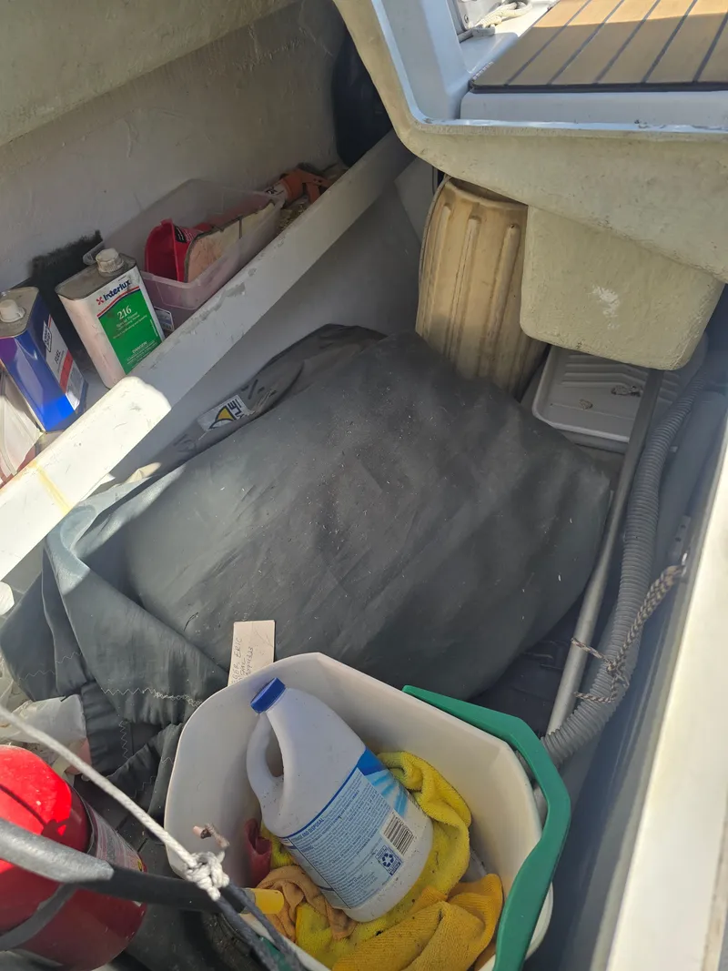 Slide: The Image of Interior of a 1994 Beneteau First 265 with cleaning supplies. - 6