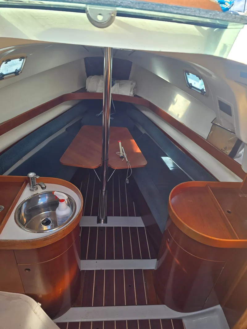 Slide: The Image of Interior of a 1994 Beneteau First 265 yacht with wooden furnishings. - 9