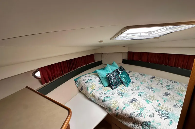 Slide: The Image of Interior of 1998 Carver 355 Aft Cabin Motor Yacht with cozy bed and decorative pillows. - 10