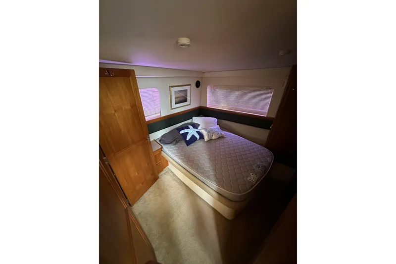 Slide: The Image of Interior cabin of 1998 Carver 355 Aft Cabin Motor Yacht with bed and wooden cabinetry. - 13