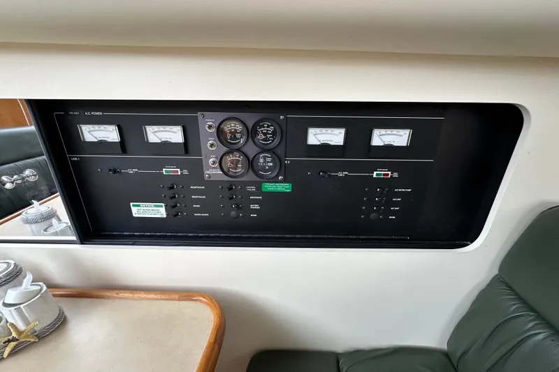 Slide: The Image of Control panel of a 1998 Carver 355 Aft Cabin Motor Yacht, featuring gauges and switches. - 16