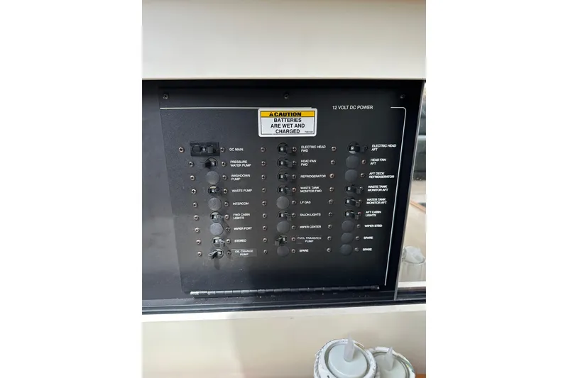 Slide: The Image of 1998 Carver 355 Aft Cabin Motor Yacht control panel with various switches and indicators. - 17