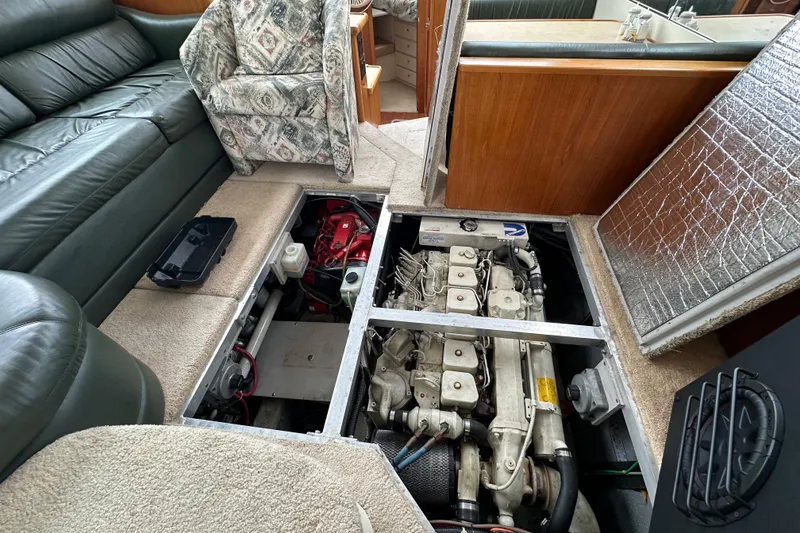 Slide: The Image of 1998 Carver 355 Aft Cabin Motor Yacht engine compartment with visible seating and interior details. - 18