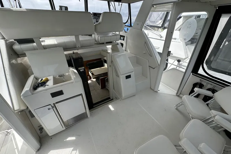 Slide: The Image of 1998 Carver 355 Aft Cabin Motor Yacht interior with seating and kitchenette. - 4