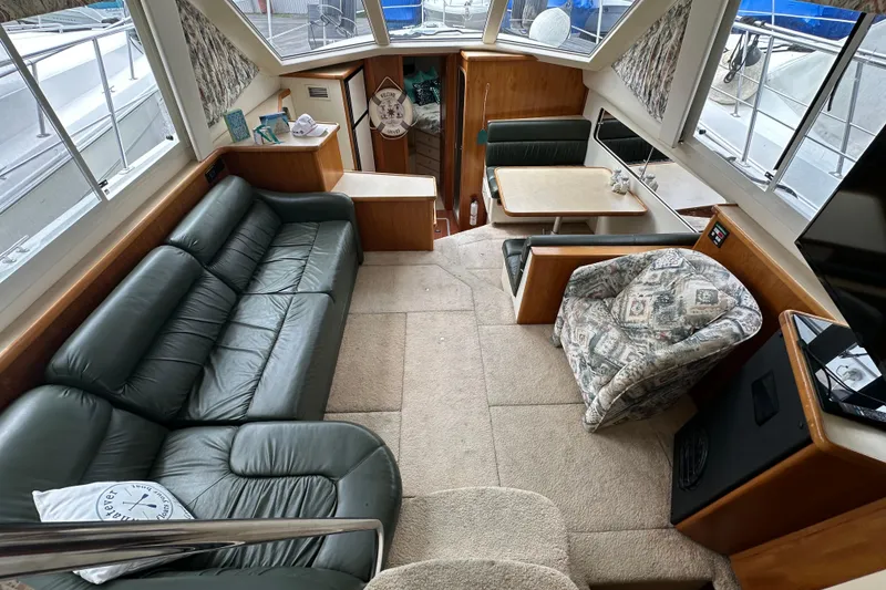 Slide: The Image of Interior of 1998 Carver 355 Aft Cabin Motor Yacht with leather sofa and dining area. - 7