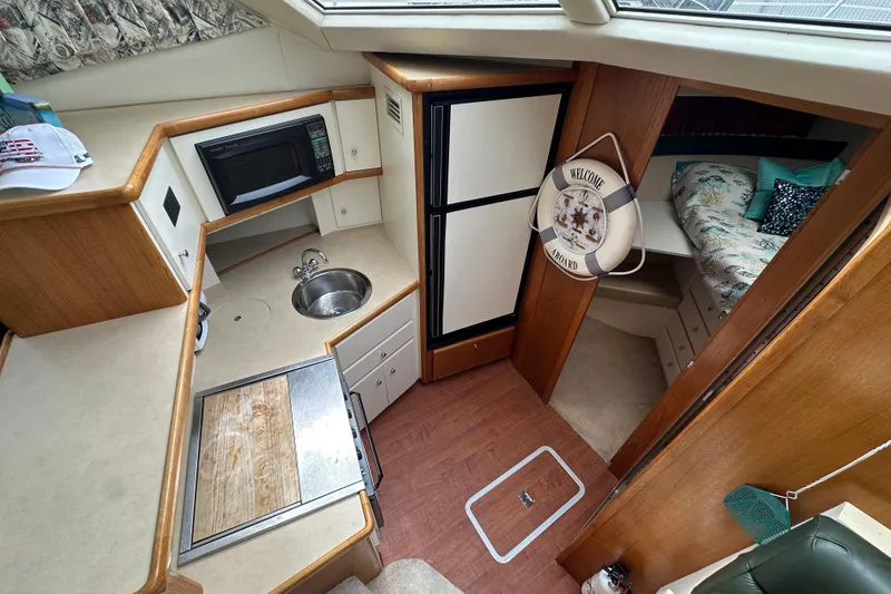 Slide: The Image of Interior of 1998 Carver 355 Aft Cabin Motor Yacht with kitchen and cozy sleeping area. - 9