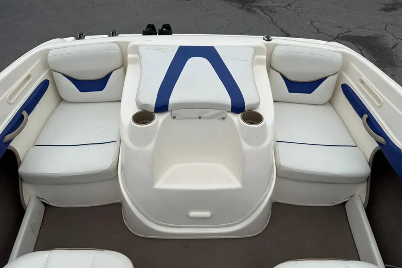 Slide: The Image of Interior seating of a 2003 Bayliner 185 boat with white and blue upholstery. - 11