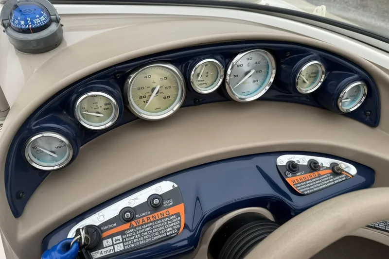 Slide: The Image of Dashboard of a 2003 Bayliner 185 boat with gauges and controls. - 15
