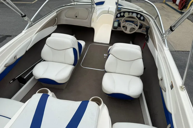 Slide: The Image of Interior of a 2003 Bayliner 185 boat with white and blue seating. - 8