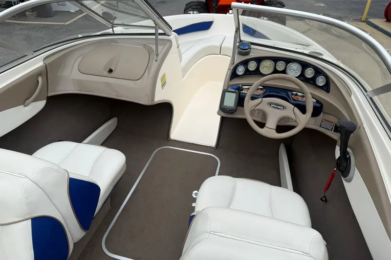 Slide: The Image of Interior of a 2003 Bayliner 185 boat with steering wheel and dashboard controls. - 9