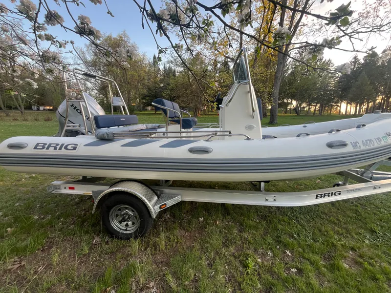 Slide: The Image of 2022 Brig Navigator 570 inflatable boat on trailer outdoors. - 11
