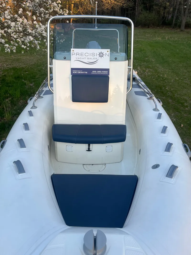 Slide: The Image of 2022 Brig Navigator 570 boat with blue seating outdoors. - 3