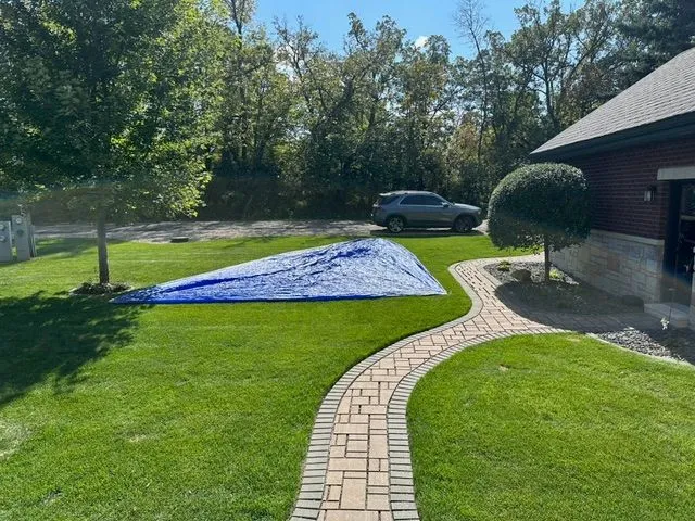 Slide: The Image of Beneteau First 24 sail on green lawn beside brick pathway. - 10