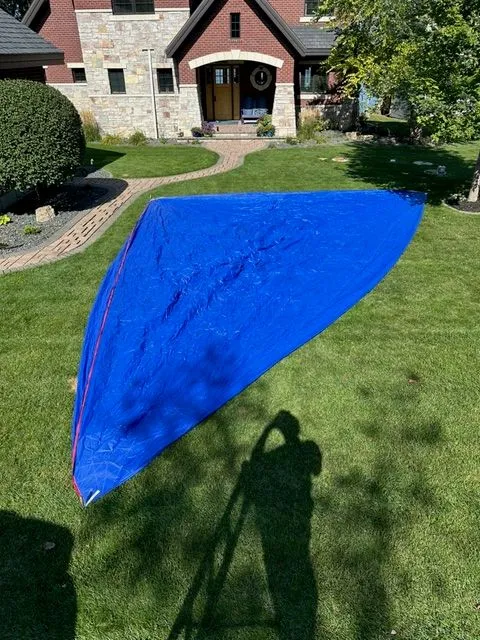 Slide: The Image of Blue sail on lawn in front of brick house, Beneteau First 24, 2021. - 13