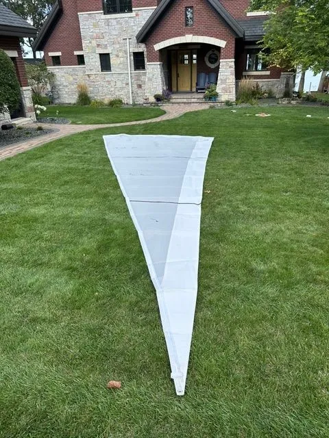 Slide: The Image of Sail on lawn in front of brick house, Beneteau First 24, 2021. - 15