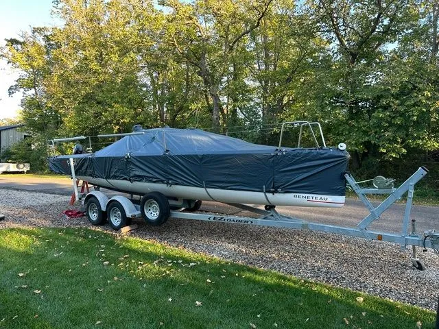 Slide: The Image of 2021 Beneteau First 24 sailboat on trailer, covered, parked outdoors. - 3