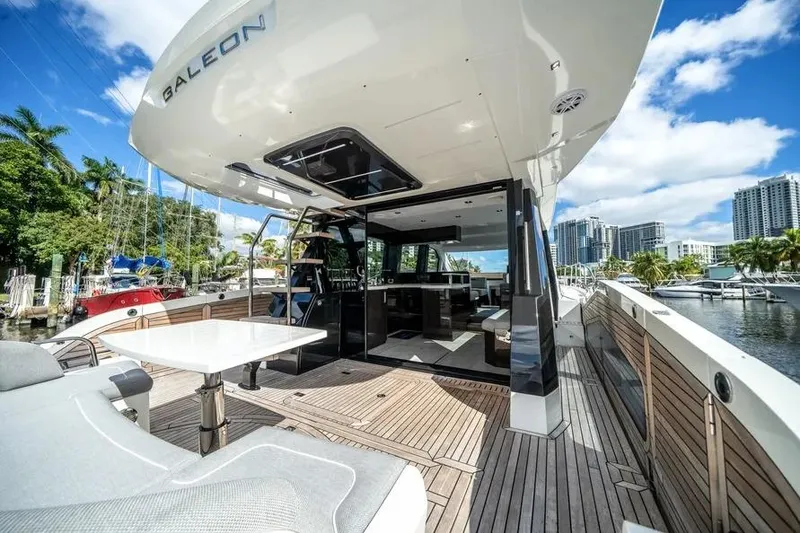 Slide: The Image of 2024 Galeon 500 Fly yacht with spacious deck and modern interior, docked in a marina. - 13