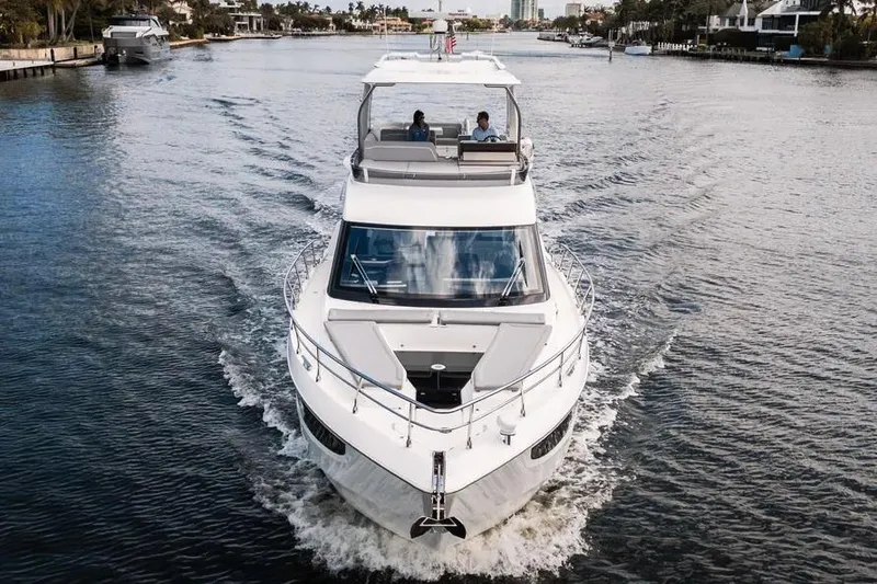 Slide: The Image of 2024 Galeon 500 Fly yacht cruising on a scenic waterway. - 2